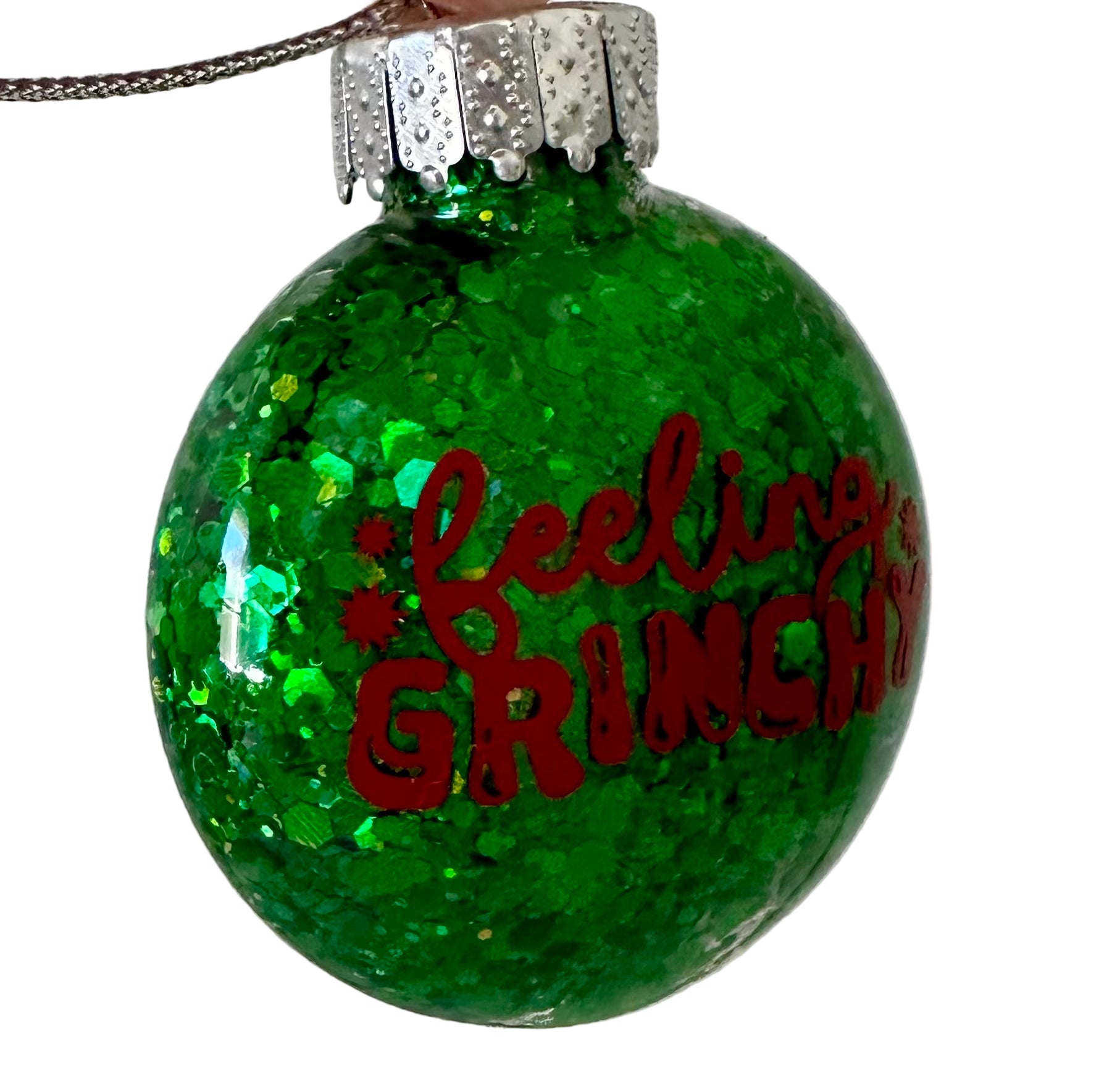 Grinch themed holiday ornament with sparkle and festive design