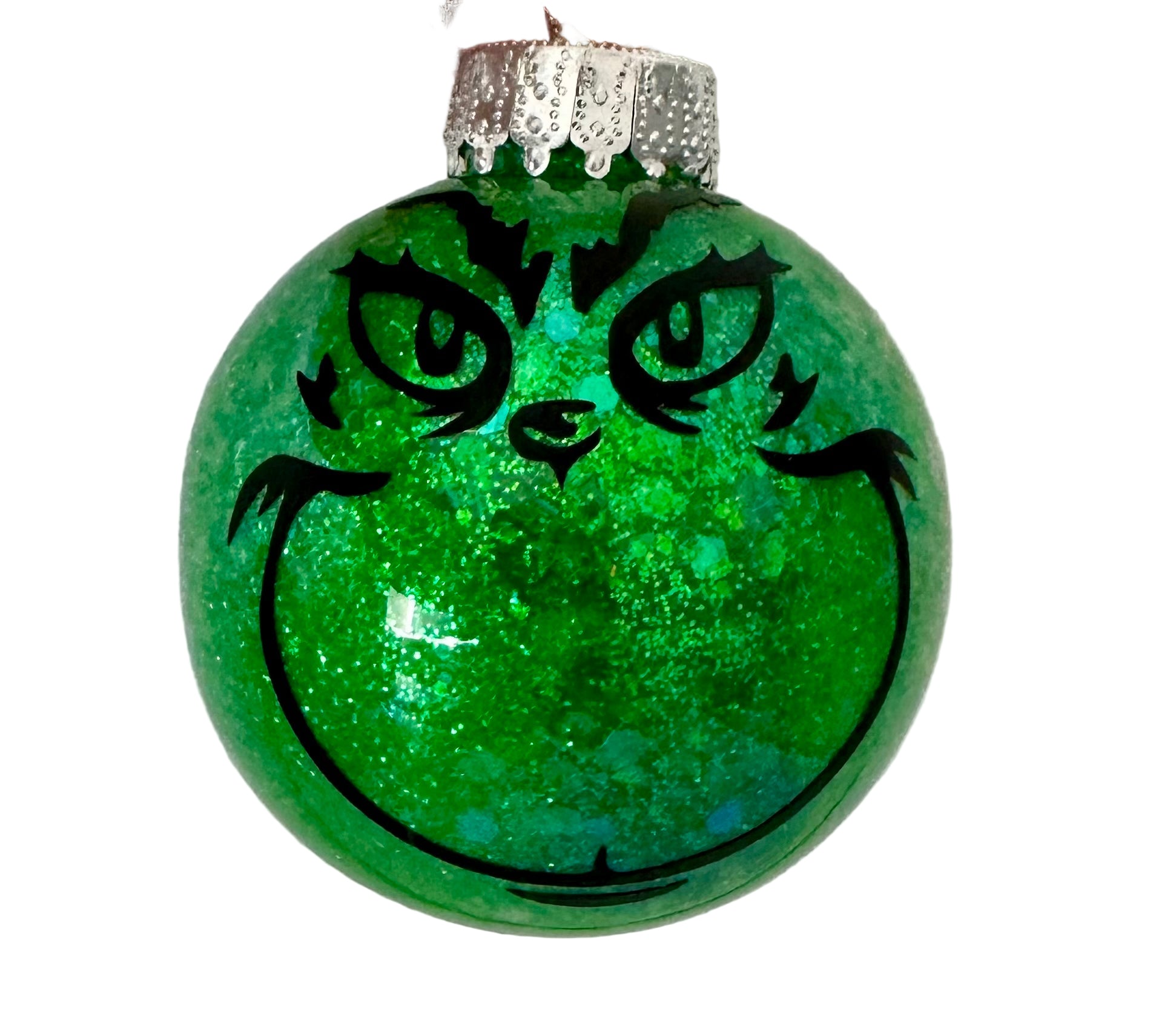 Grinch face ornament with green glitter and mischievous grin