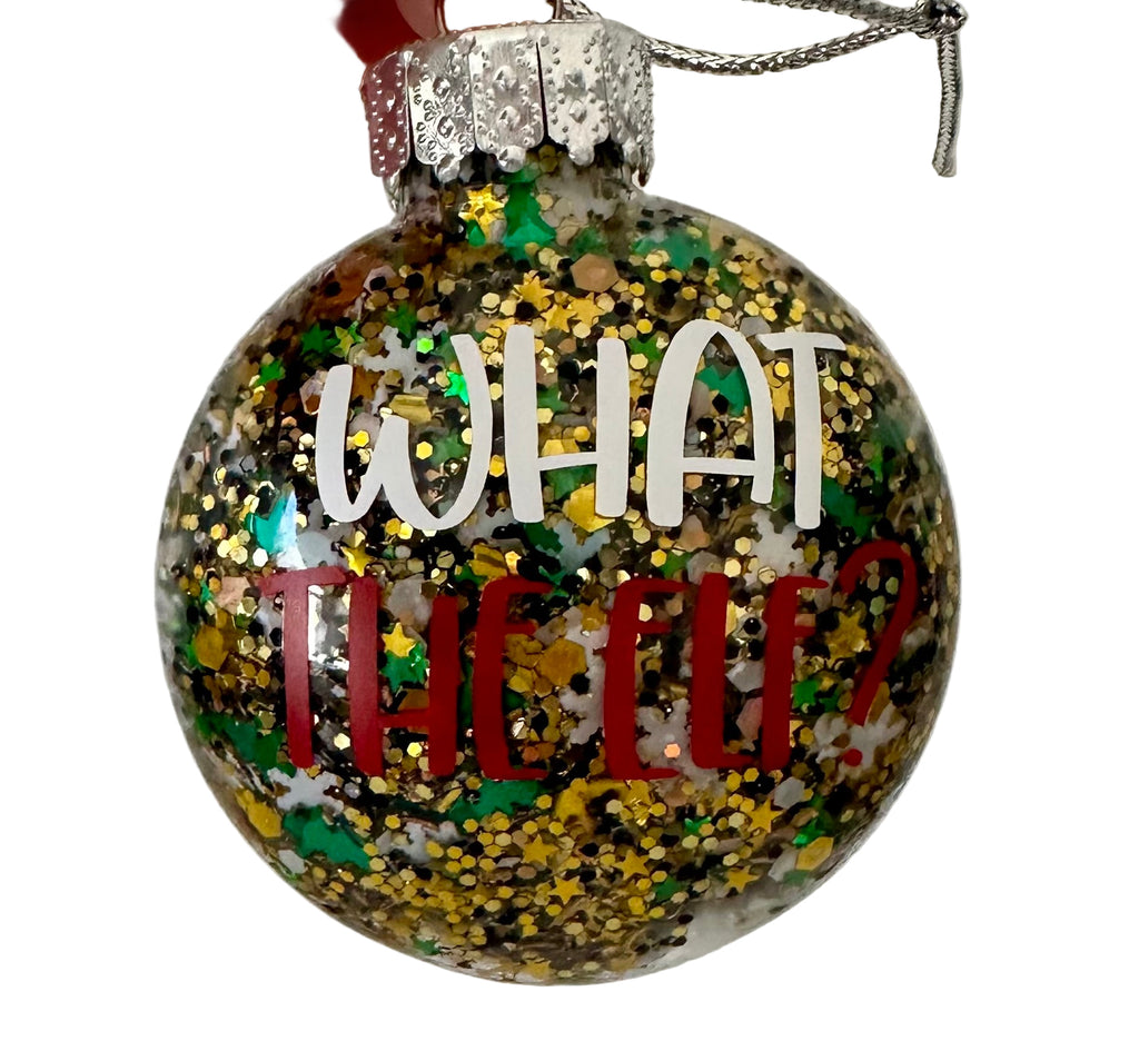 Glitter holiday ornament with What the Elf text and elf prints on back