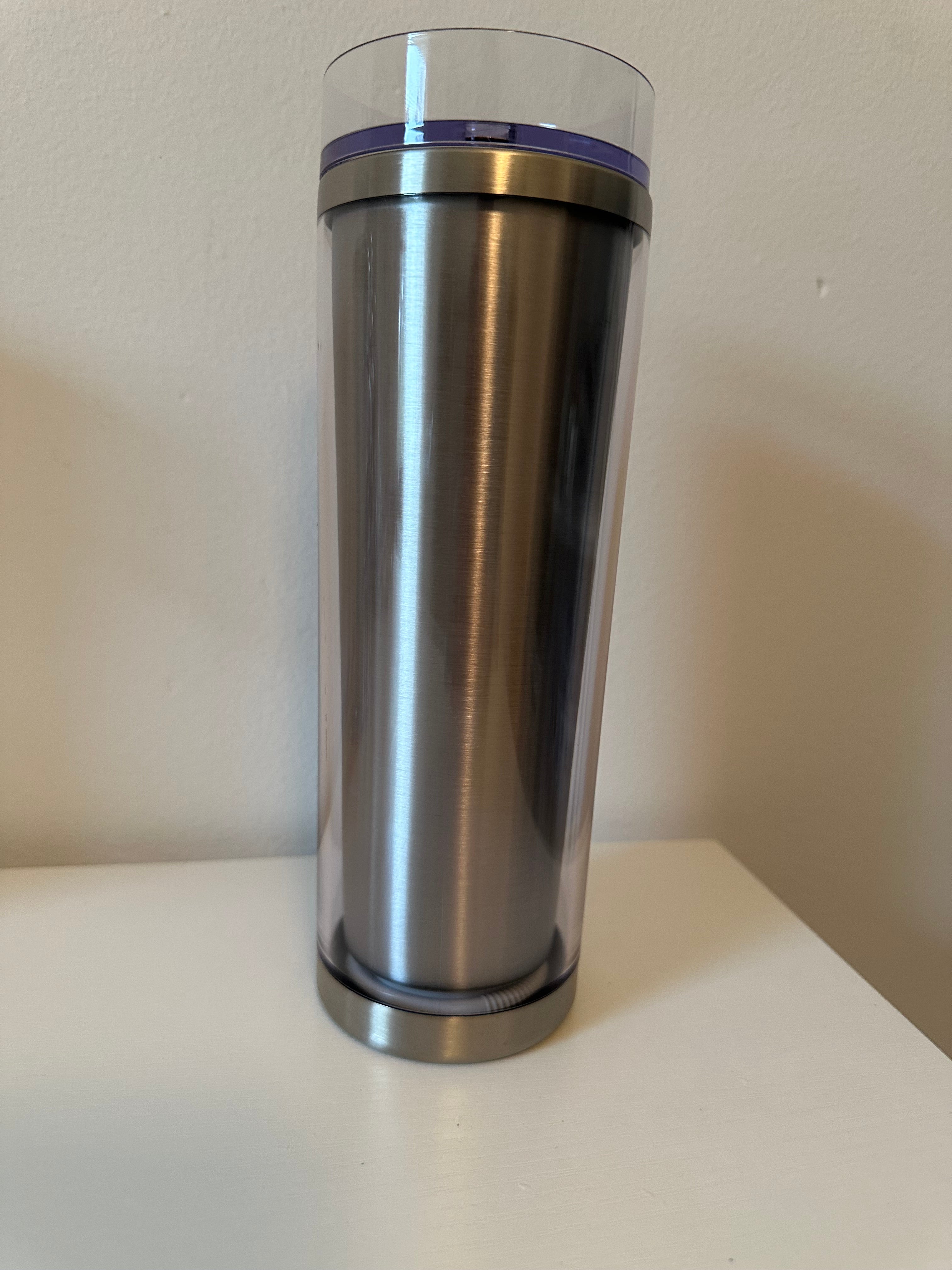Silver cylindrical object with a clear band on a white background