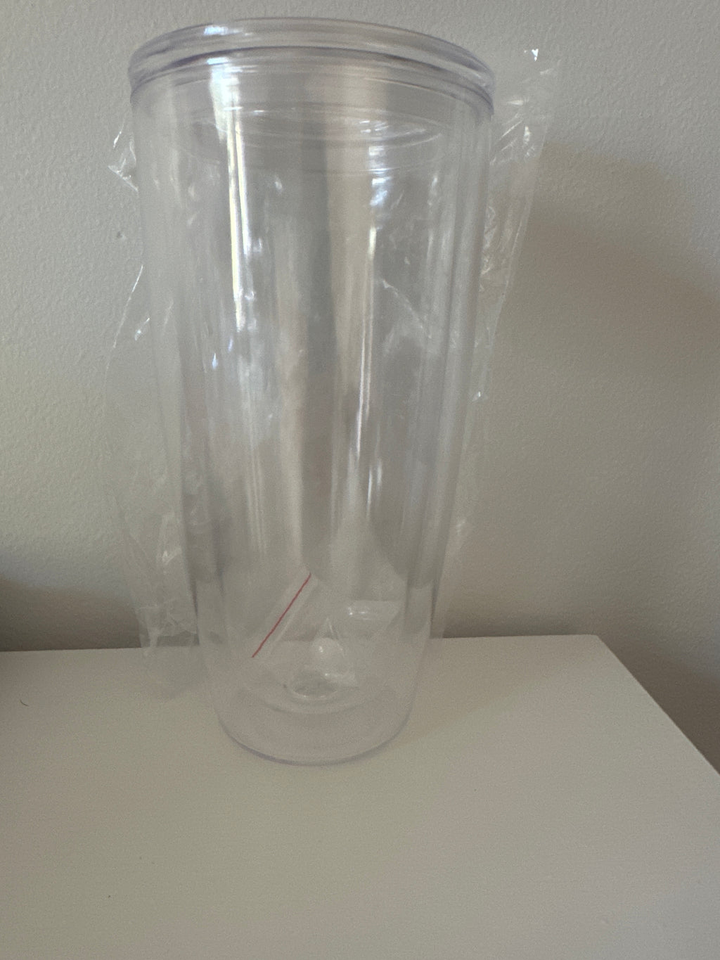 Clear plastic cups with lids on a white surface