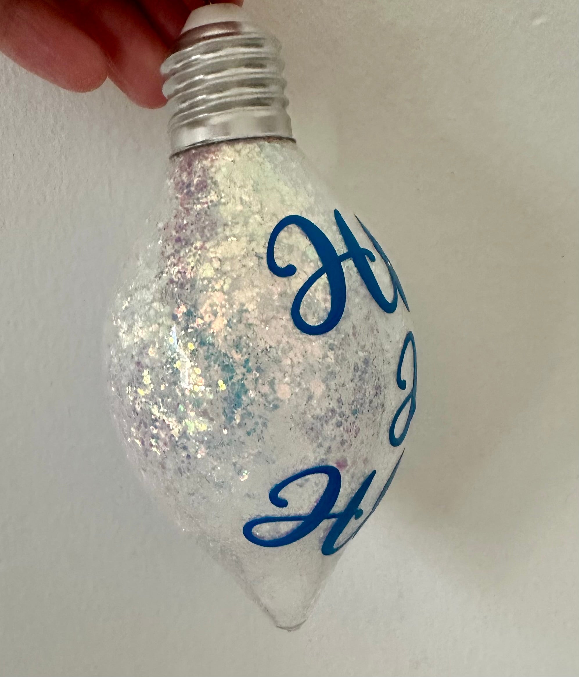 Opal glitter holiday bulb ornament with festive Ho Ho Ho phrase