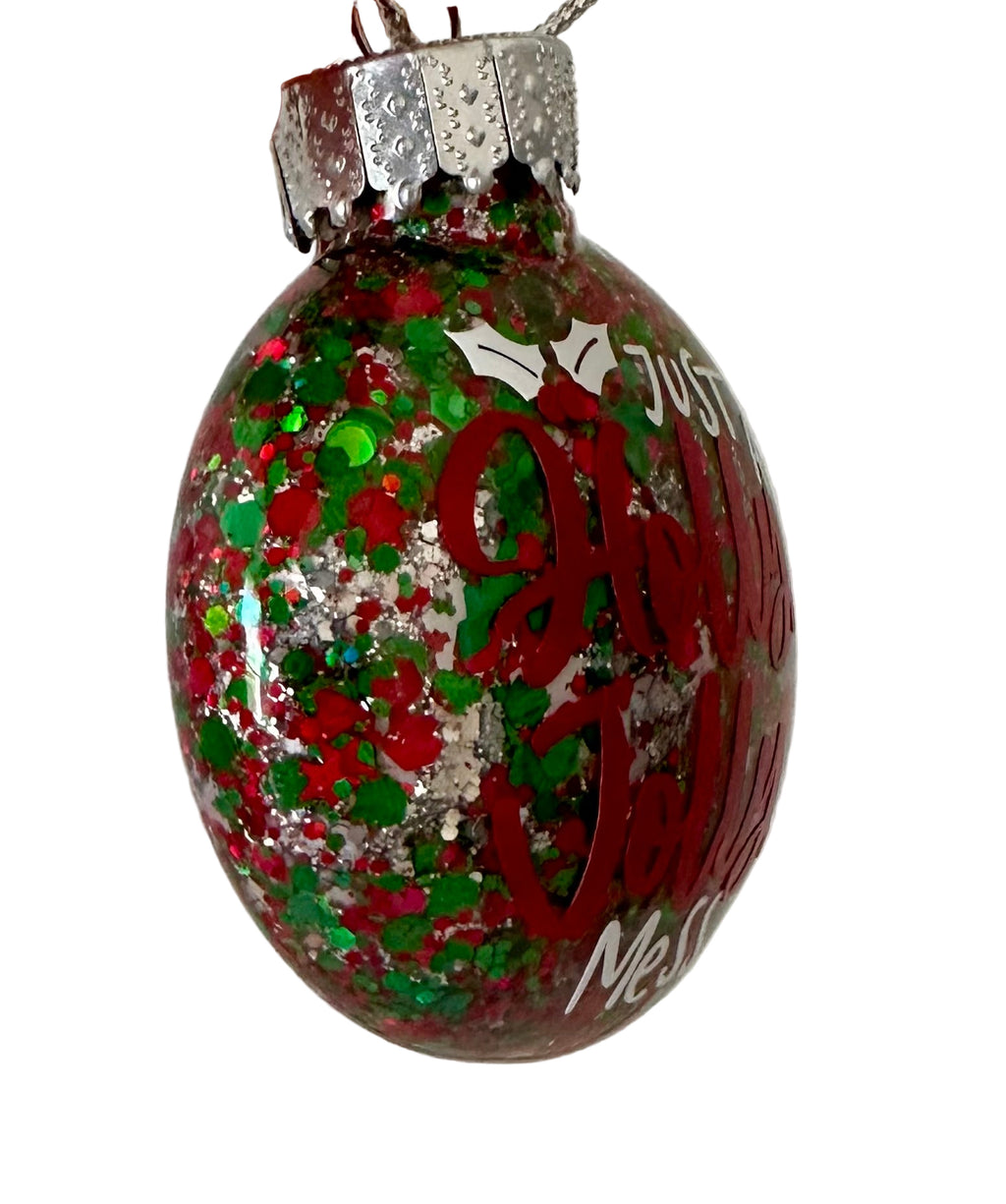 Flat Christmas ornament with Holly Jolly Mess phrase and festive colors