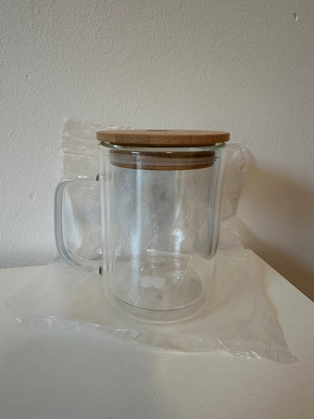Clear glass jar with a metal lid on a white background